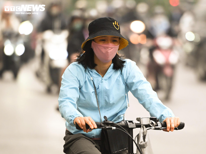 Người dân bịt kín khẩu trang di chuyển trên đường Nguyễn Trãi (phường Thanh Xuân). (Ảnh: Thành Vĩnh)