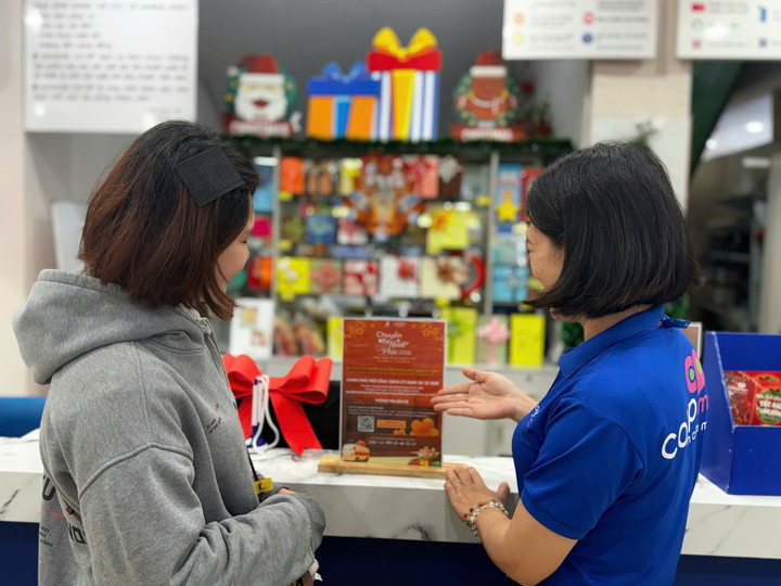 Nhân viên Co.opmart tư vấn thông tin về chương trình cho khách hàng.