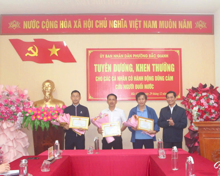 Ông Nguyễn Văn Tình - Chủ tịch UBND phường Bắc Gianh (Quảng Trị) trao giấy khen cho hành động dũng cảm cứu người của cha con anh Nguyễn Thành Viên, Nguyễn Văn Ngọc và anh Ngô Bá Văn.