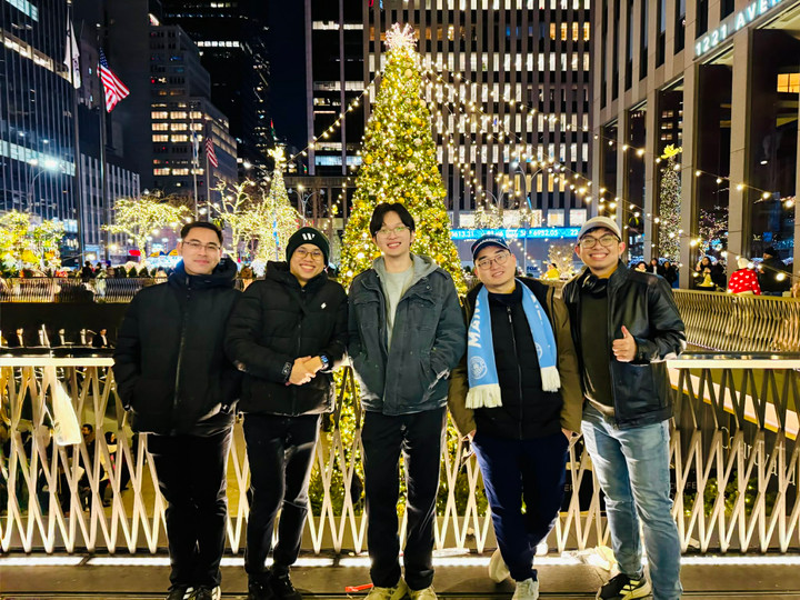 Hoàng Trung Hiếu (thứ 2, từ trái sang) cùng các bạn đón năm mới tại thành phố New York, Mỹ với khung cảnh sáng rực đặc trưng trong mùa Noel và năm mới 2026.