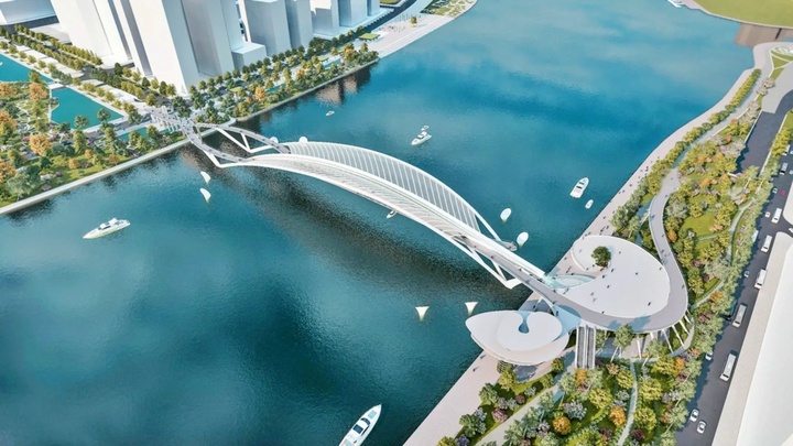 Dự án cầu đi bộ qua sông Sài Gòn được khởi công cuối tháng 3/2025, dự kiến hoàn thành tháng 9/2026. Cầu được thiết kế theo hình dáng lá dừa nước - loài cây đặc trưng của vùng sông nước Nam Bộ và được đánh giá là phương án kiến trúc tạo điểm nhấn cho cảnh quan đô thị trung tâm TP.HCM. (Ảnh: Phối cảnh cầu đi bộ)