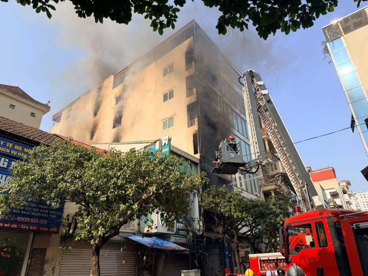 Lực lượng chức năng huy động xe chữa cháy và xe thang tiếp cận hiện trường, phun nước dập lửa.