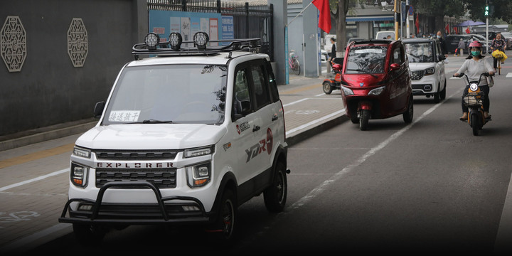 Chiếc laotoule dán dòng chữ "đưa đón trẻ em" đỗ trước một trường học ở Trung Quốc. (Ảnh: Sixthtone)