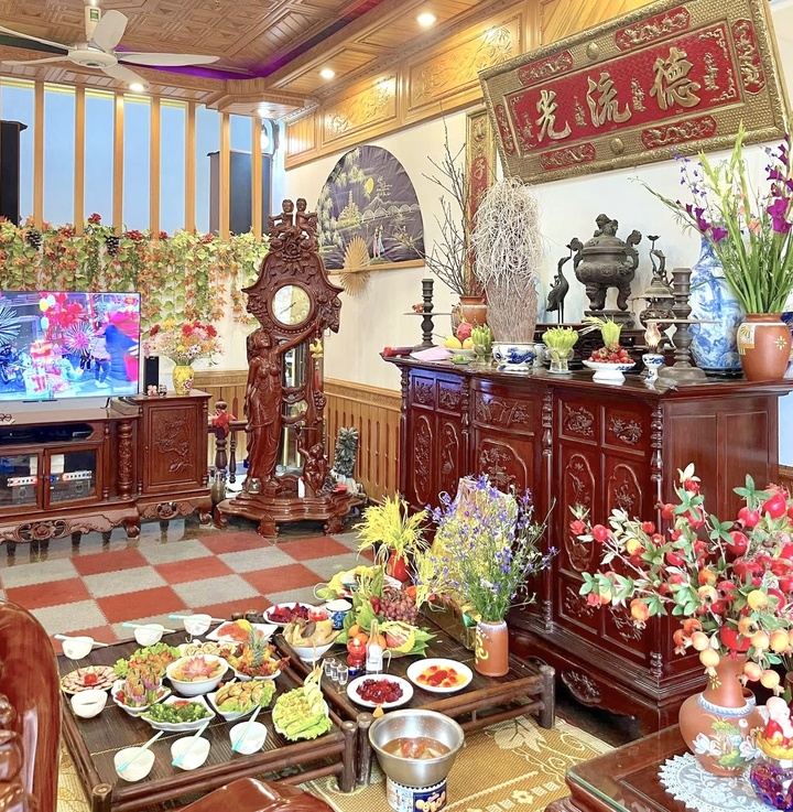 Gia đình đặt lễ cúng ông Công ông Táo trước bàn thờ gia tiên. (Ảnh: Hương Giang)