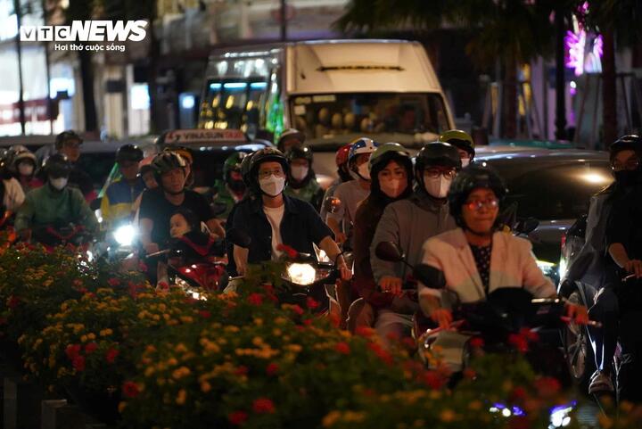 Khoảng từ 19h, dòng phương tiện từ nhiều hướng bắt đầu đổ về khu vực phố đi bộ. Càng về tối, áp lực giao thông càng gia tăng khi ai cũng tranh thủ đến thưởng lãm trước giờ bế mạc. Các trục đường bao quanh như Lê Thánh Tôn, Nam Kỳ Khởi Nghĩa, Đồng Khởi, Lý Tự Trọng, Tôn Đức Thắng ken đặc xe cộ. Nhiều đoạn phương tiện gần như “chôn chân”, nhích từng mét giữa biển người.