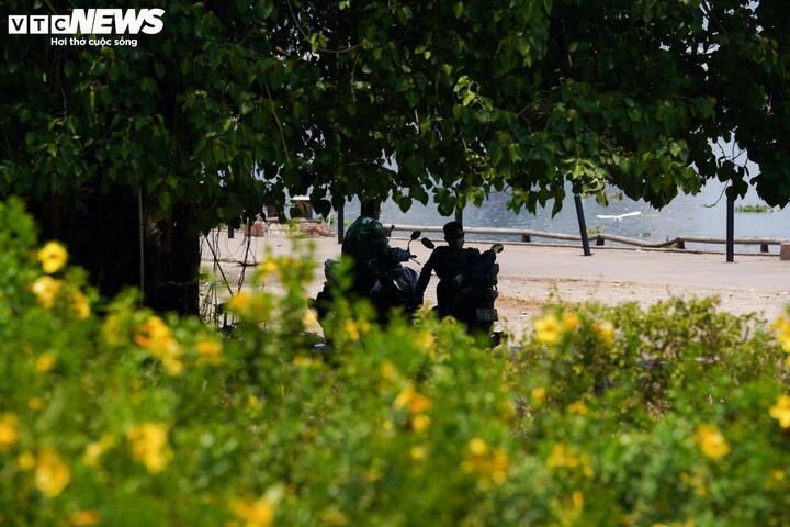 Người dân tranh thủ tìm bóng râm nghỉ ngơi giữa nắng nóng.