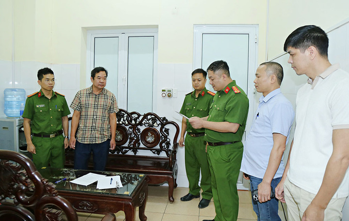 Cơ quan Cảnh sát điều tra Công an tỉnh khám xét nơi làm việc của Hoàng Văn Huấn (áo kẻ). (Ảnh: Như Quỳnh).