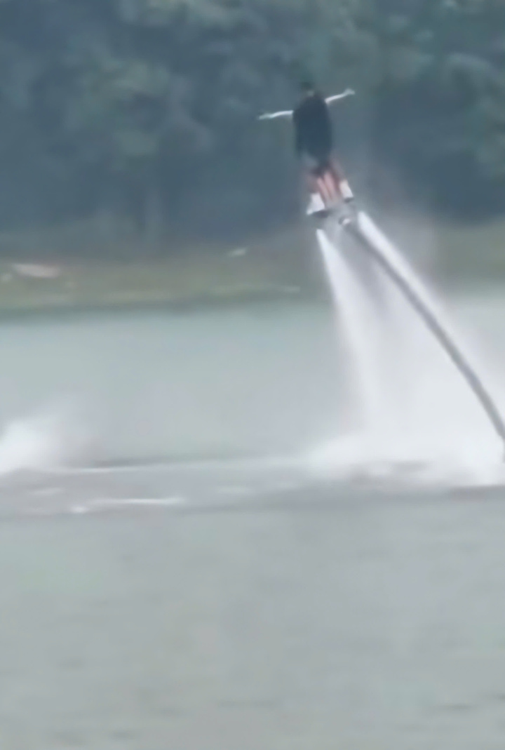 Nam vận động viên flyboard đang "bay" cùng khách thì gặp sự cố khiến cả hai chìm nghỉm dưới nước. (Ảnh cắt từ clip)