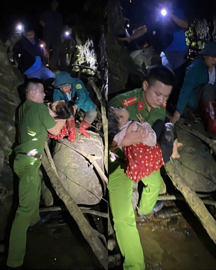 Cán bộ, chiến sĩ Công an xuống khe suối đưa cháu D. lên.