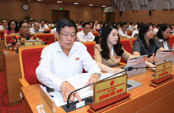 Các đại biểu bấm nút thông qua nghị quyết.