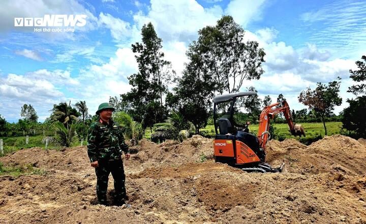 Máy xúc tìm kiếm hài cốt chiến sĩ, liệt sĩ Kiều Đăng Khoa trong vườn nhà ông Tô Điền Lâm.