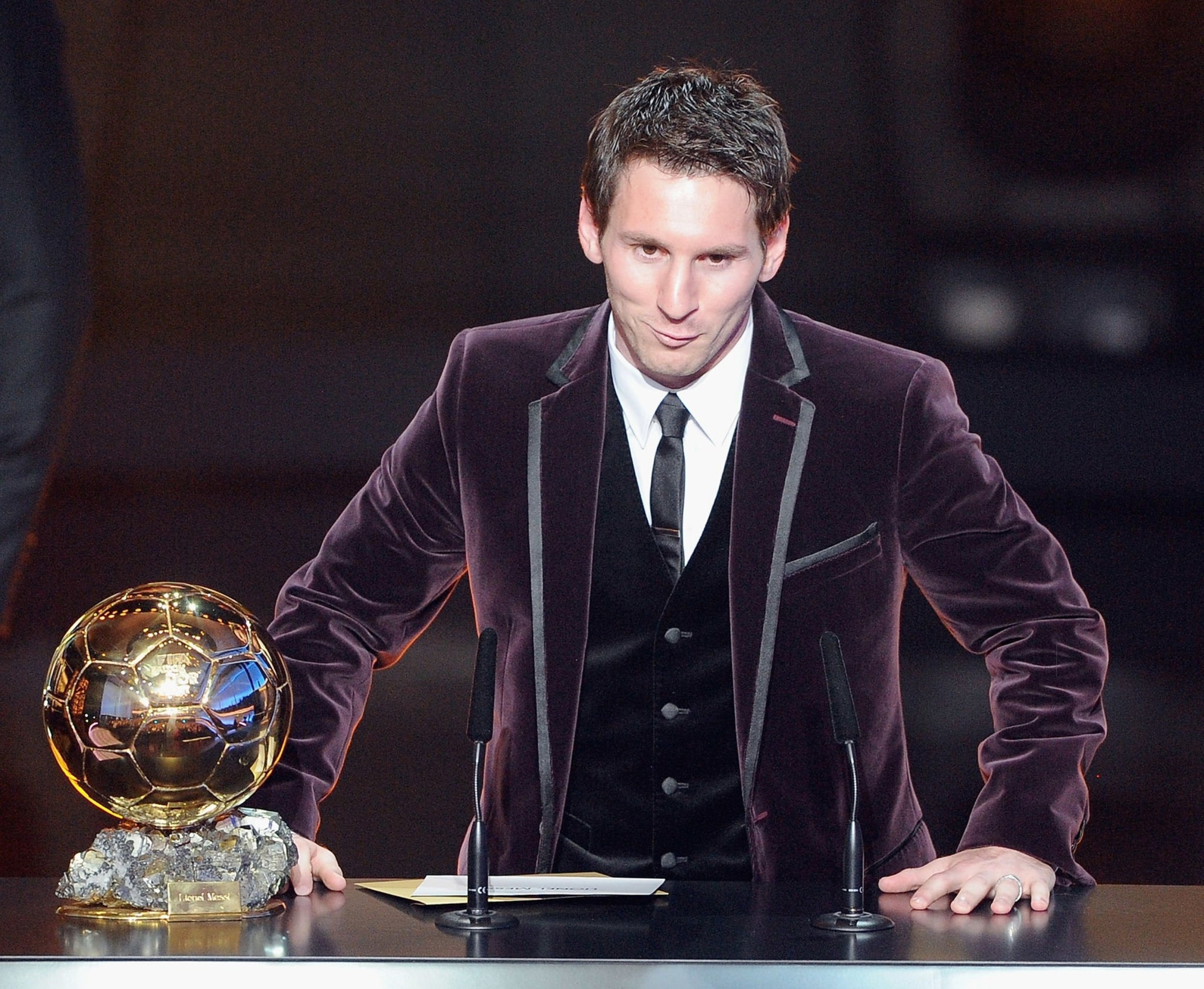 Bộ lễ phục màu tím, lần này đi kèm với áo gi-lê là điểm nhấn của Messi trong lần thứ ba nhận Quả bóng vàng. Khác biệt về ngoại hình của Messi nằm ở mái tóc được cắt ngắn gọn gàng hơn. (Ảnh: FIFA)
