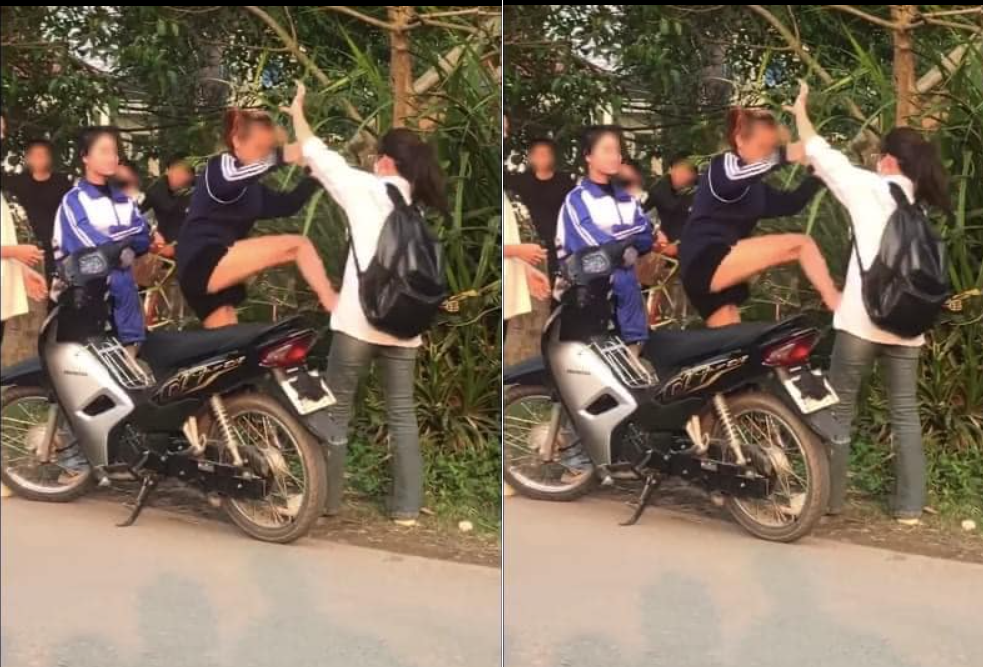 Người nhà nữ sinh Đặng Phương Thanh (áo đen) hành hung Đặng Ngọc Hà ngoài cổng trường. (Ảnh cắt từ video)